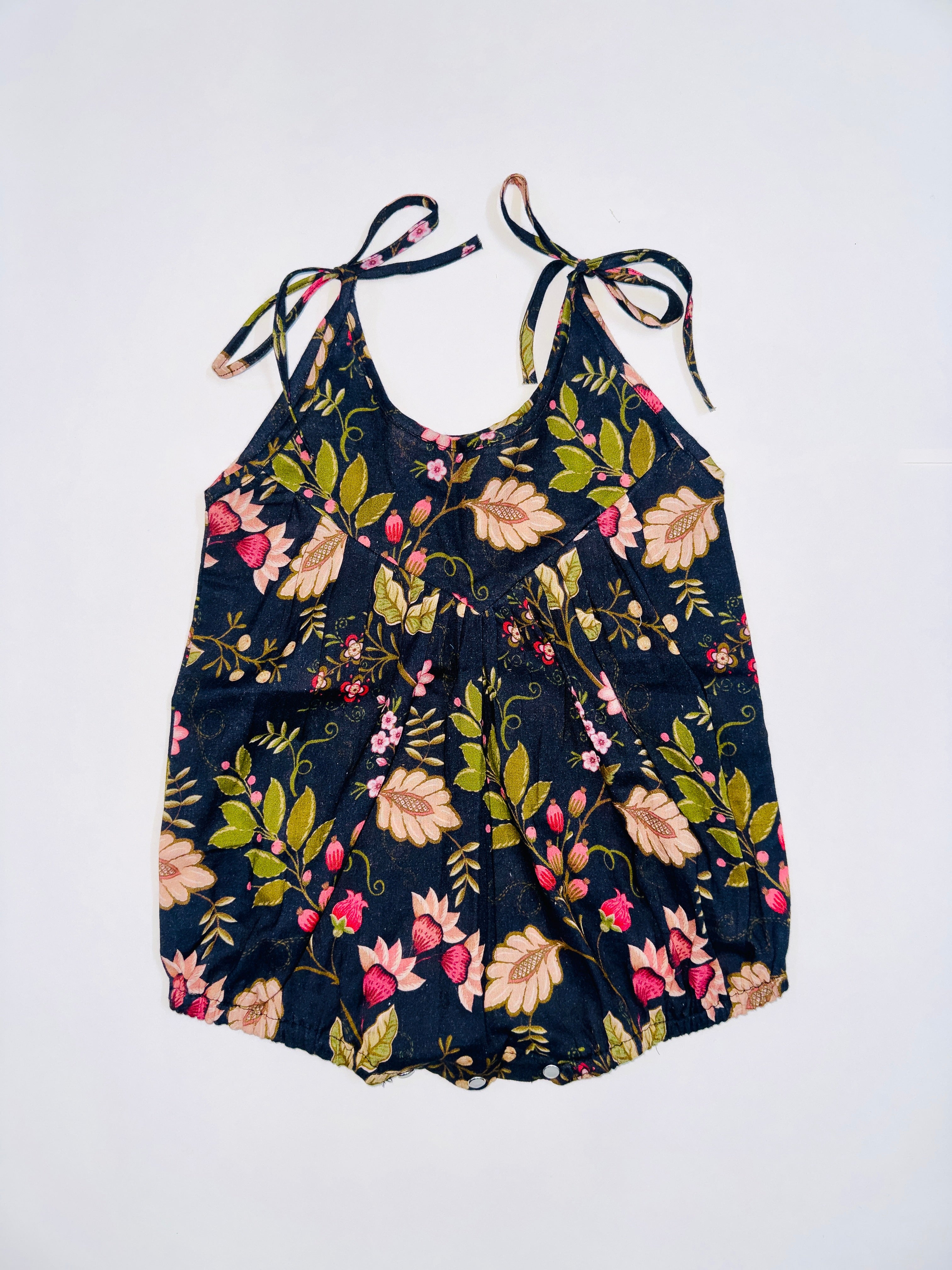Midnight Bloom Tie-Up Romper for Girls with Black Base and Floral Patterns.