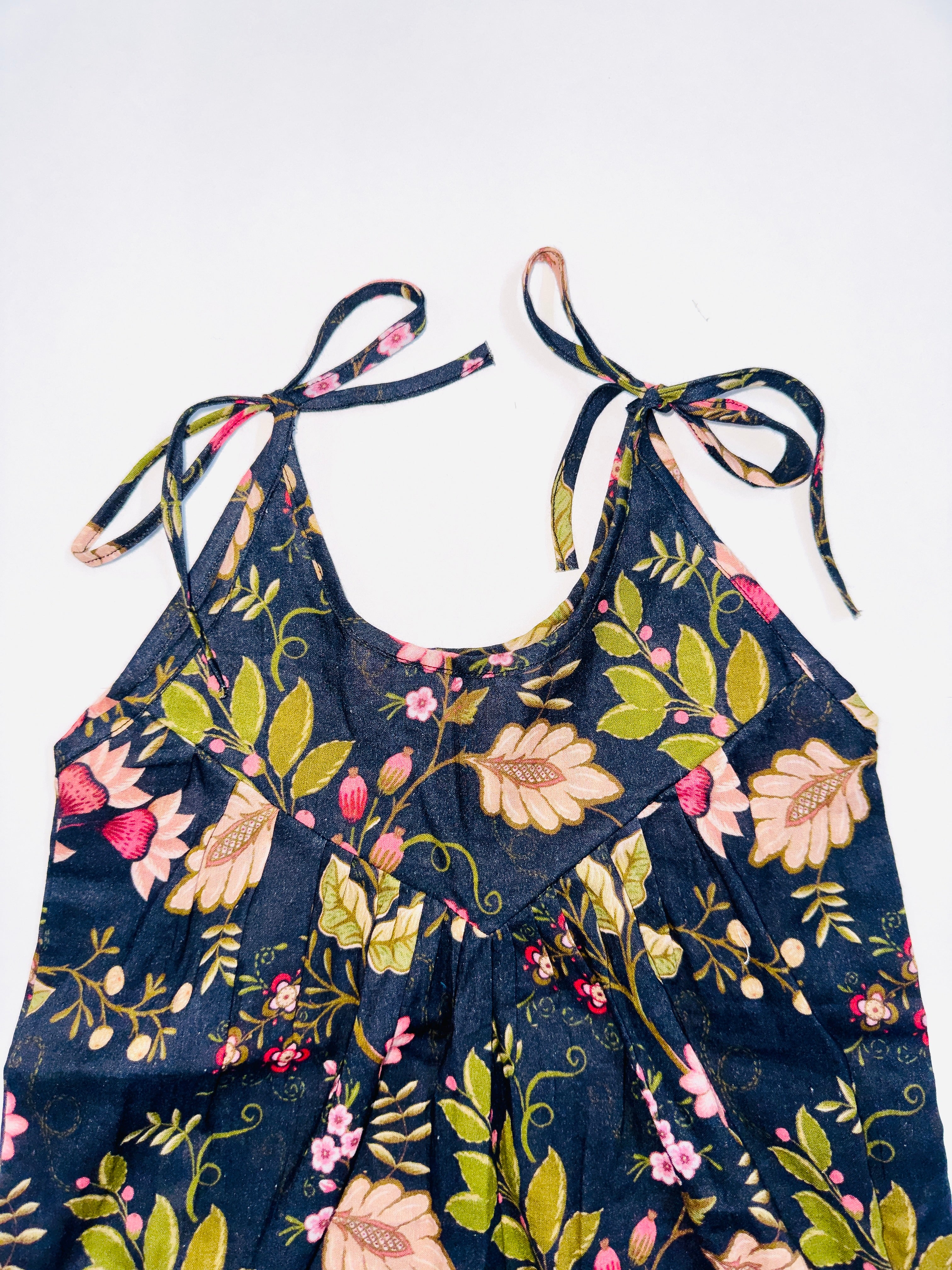 Midnight Bloom Tie-Up Romper for Girls with Black Base and Floral Patterns.
