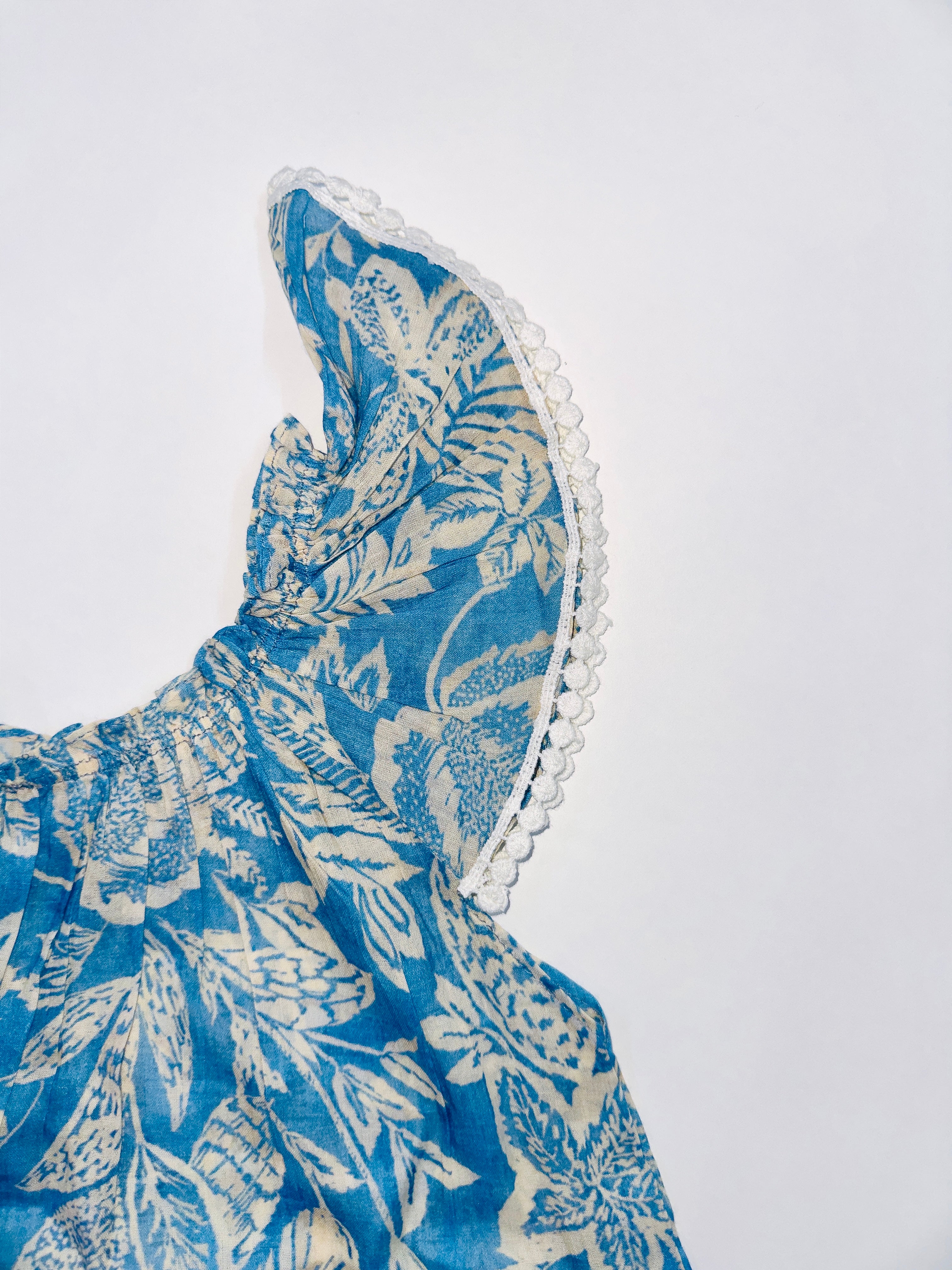 Aqua Breeze Dress with blue and White Floral Print, Lace Details, and Flutter Sleeves.
