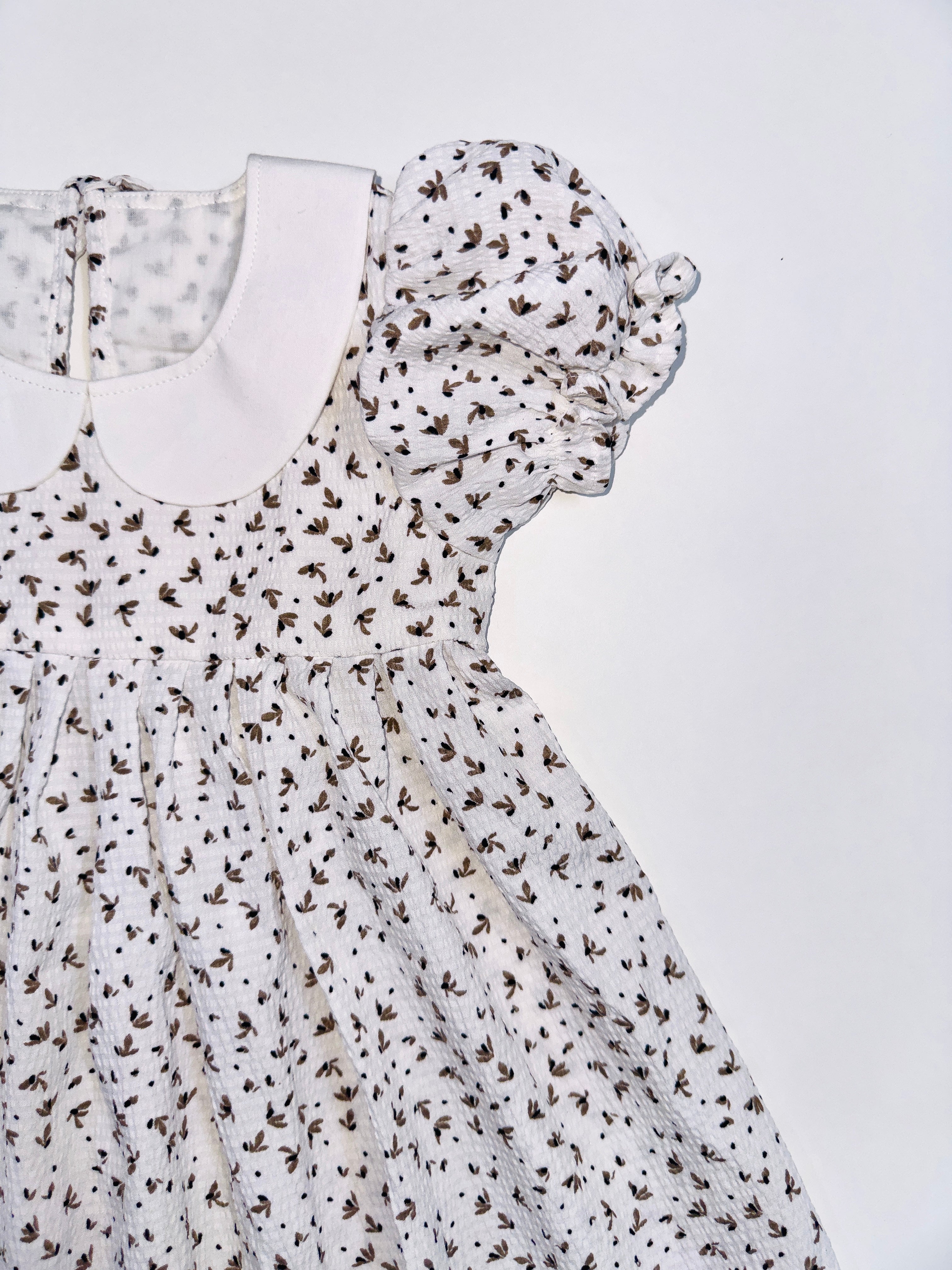 Brownie White Printed Frock with Peter Pan Collar for Baby Girls.