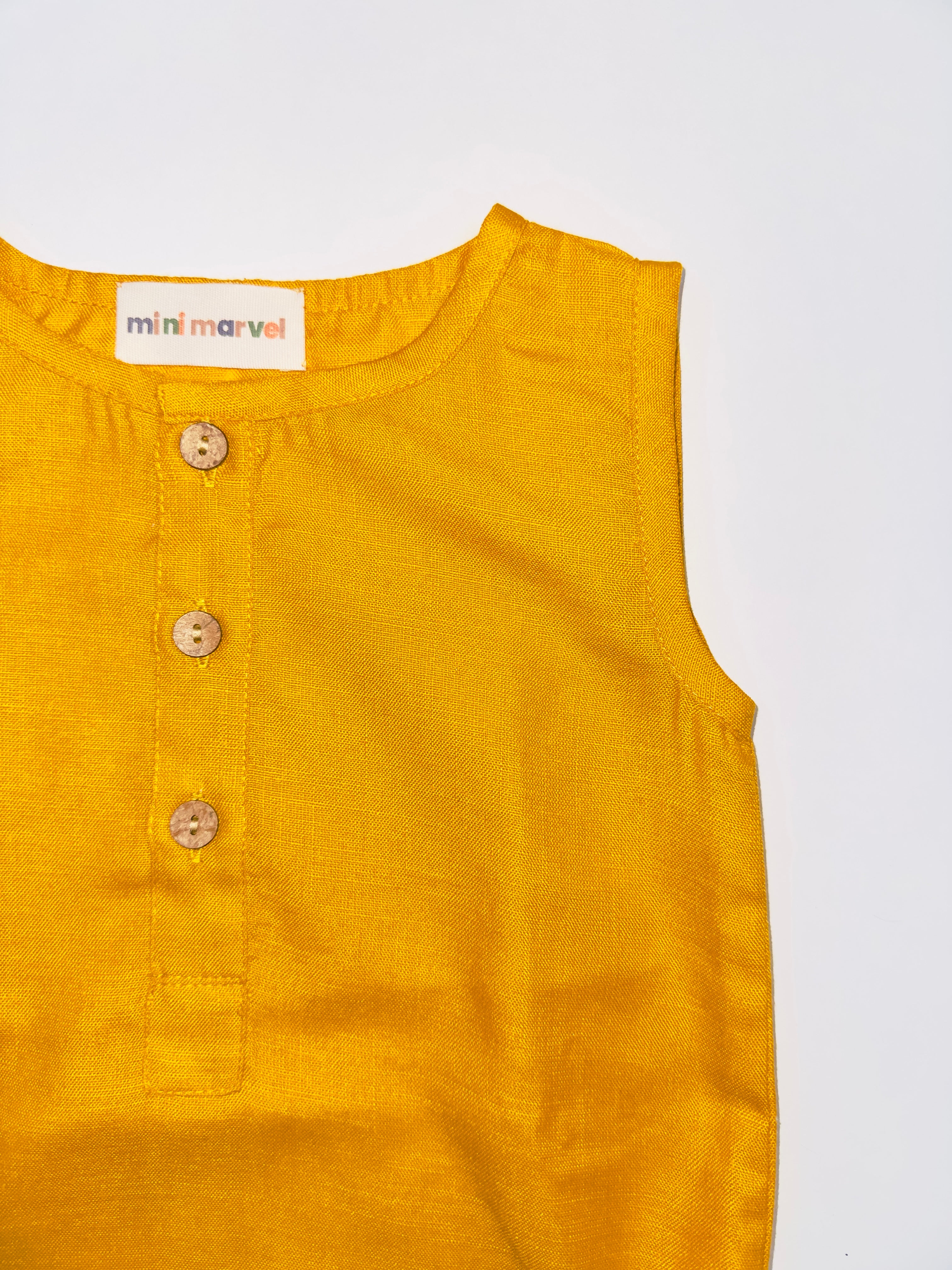 Classic Mustard Buttoned Baby Romper with Wooden Buttons and Snap Closures.