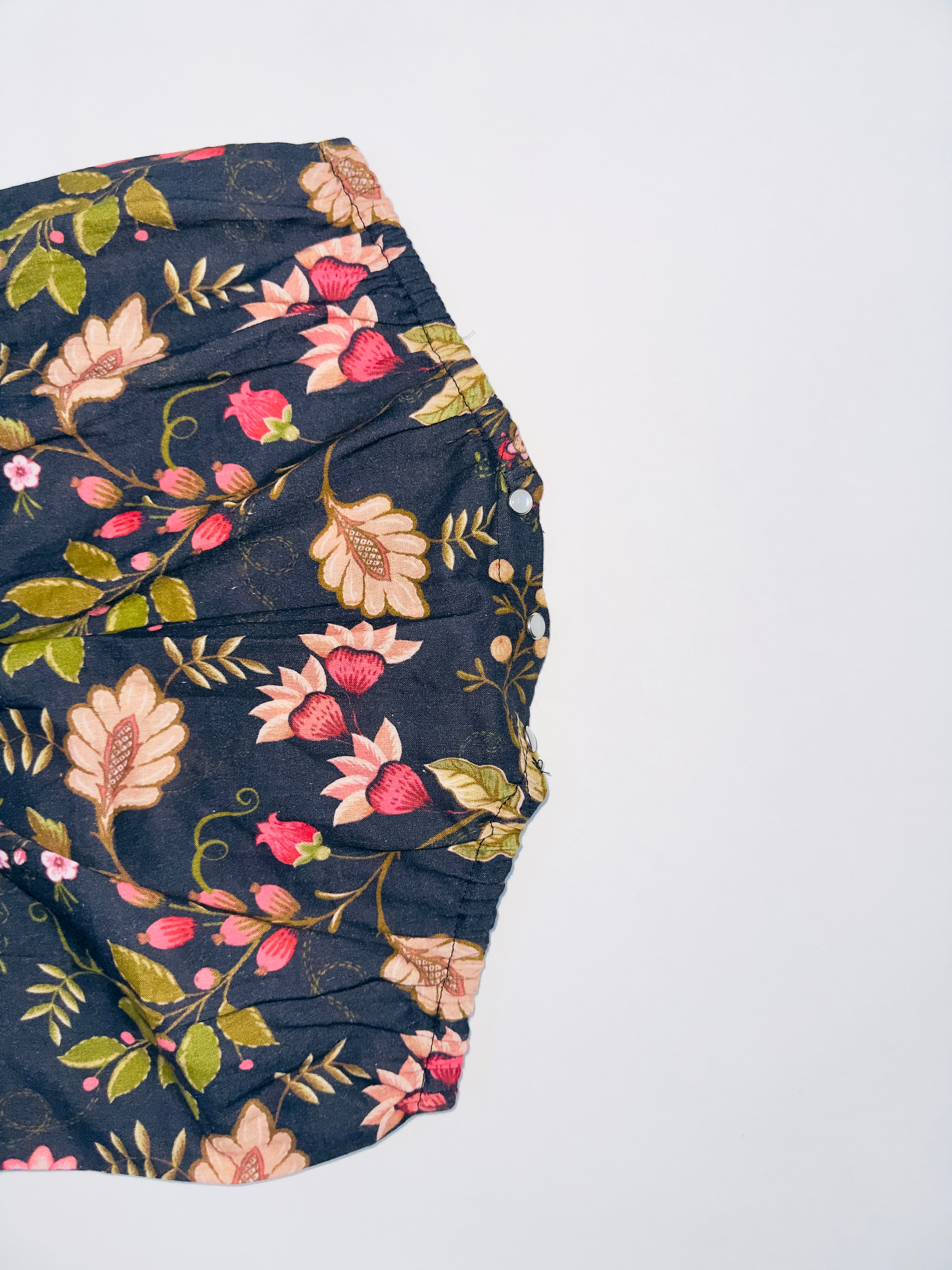 Midnight Bloom Tie-Up Romper for Girls with Black Base and Floral Patterns.