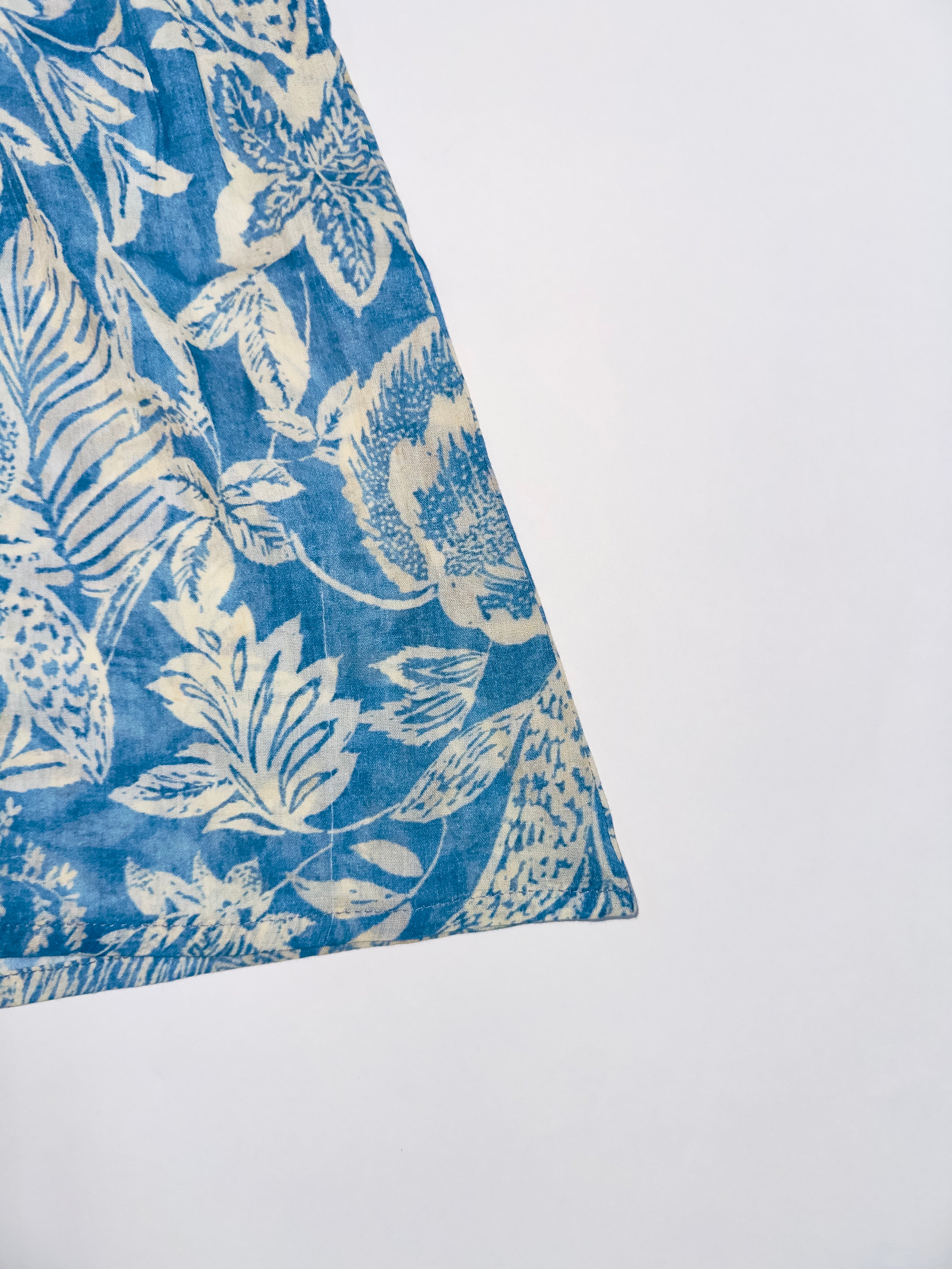 Aqua Breeze Dress with blue and White Floral Print, Lace Details, and Flutter Sleeves.