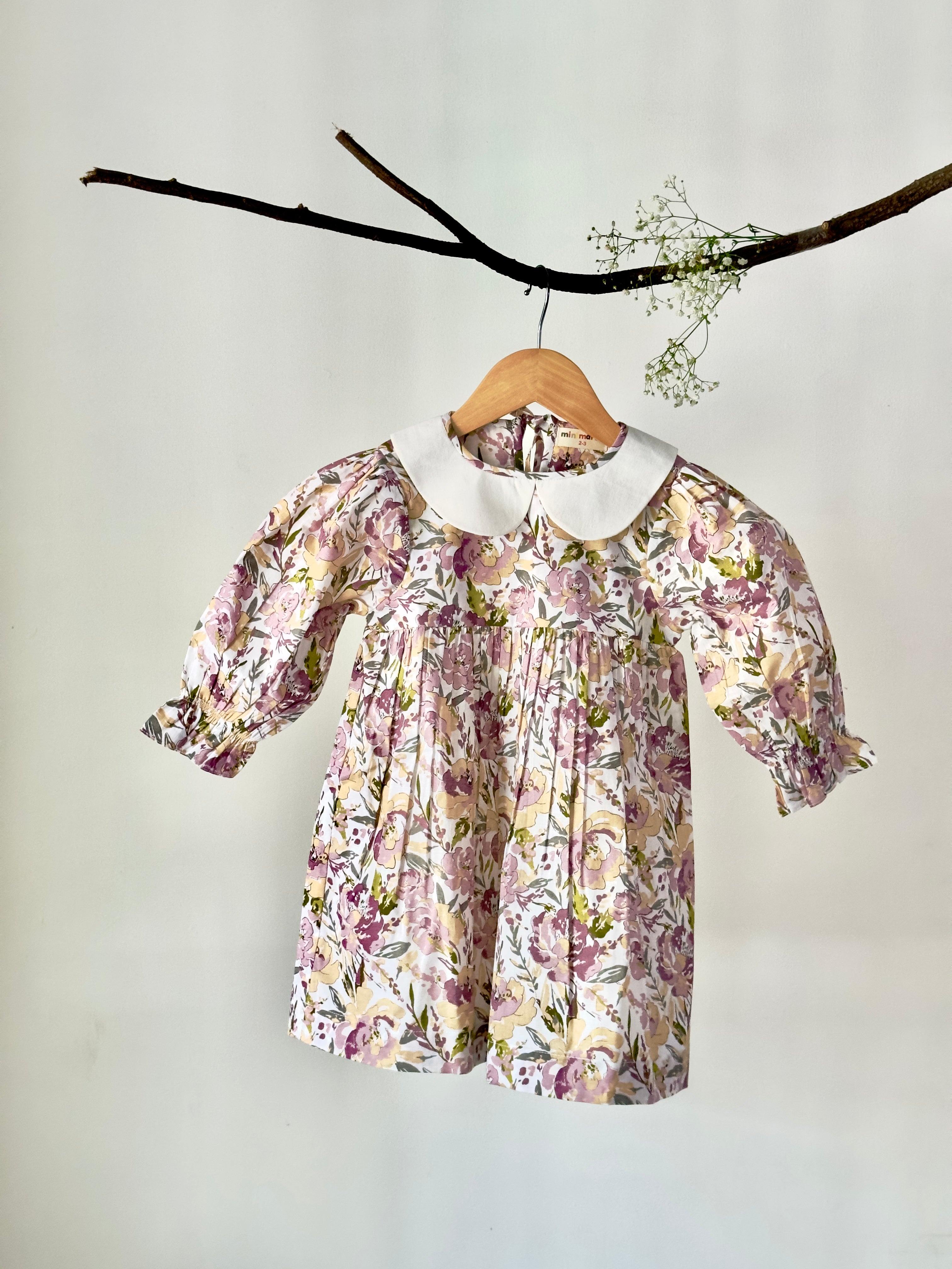 Floral pastel cotton dress with vintage collar displayed on hanger