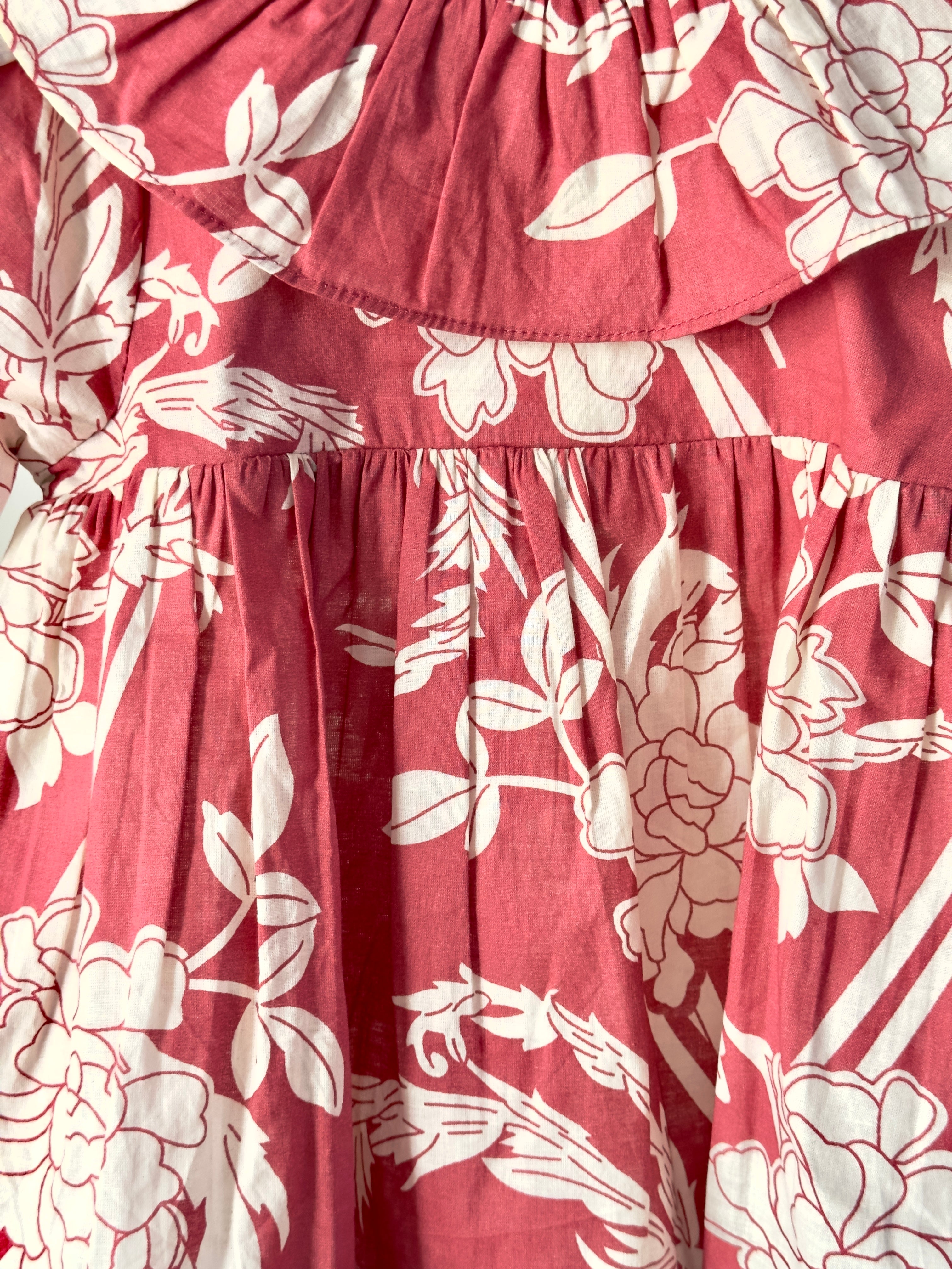 Girls floral top paired with cream cotton bottoms