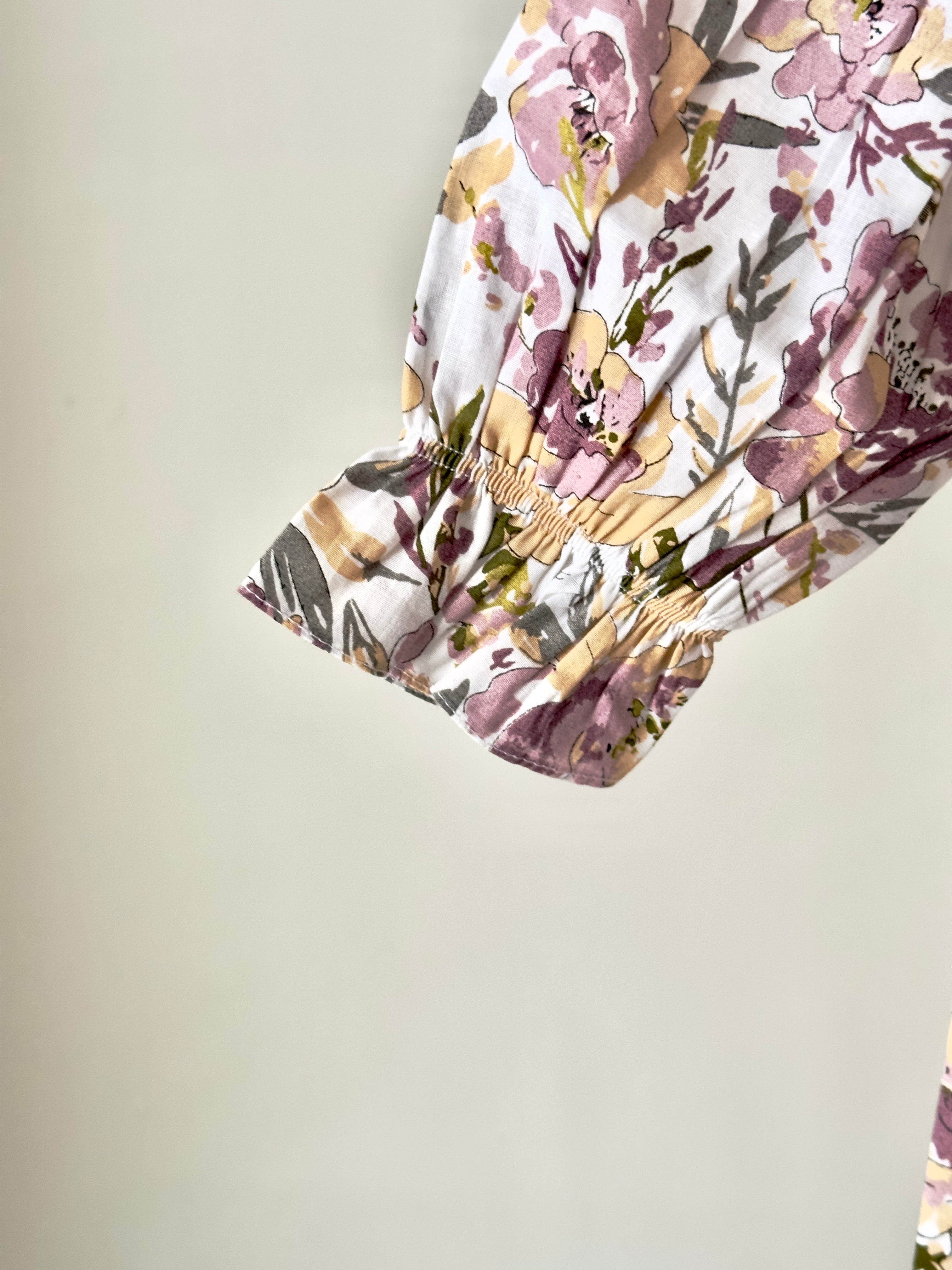 Floral pastel cotton dress with vintage collar displayed on hanger