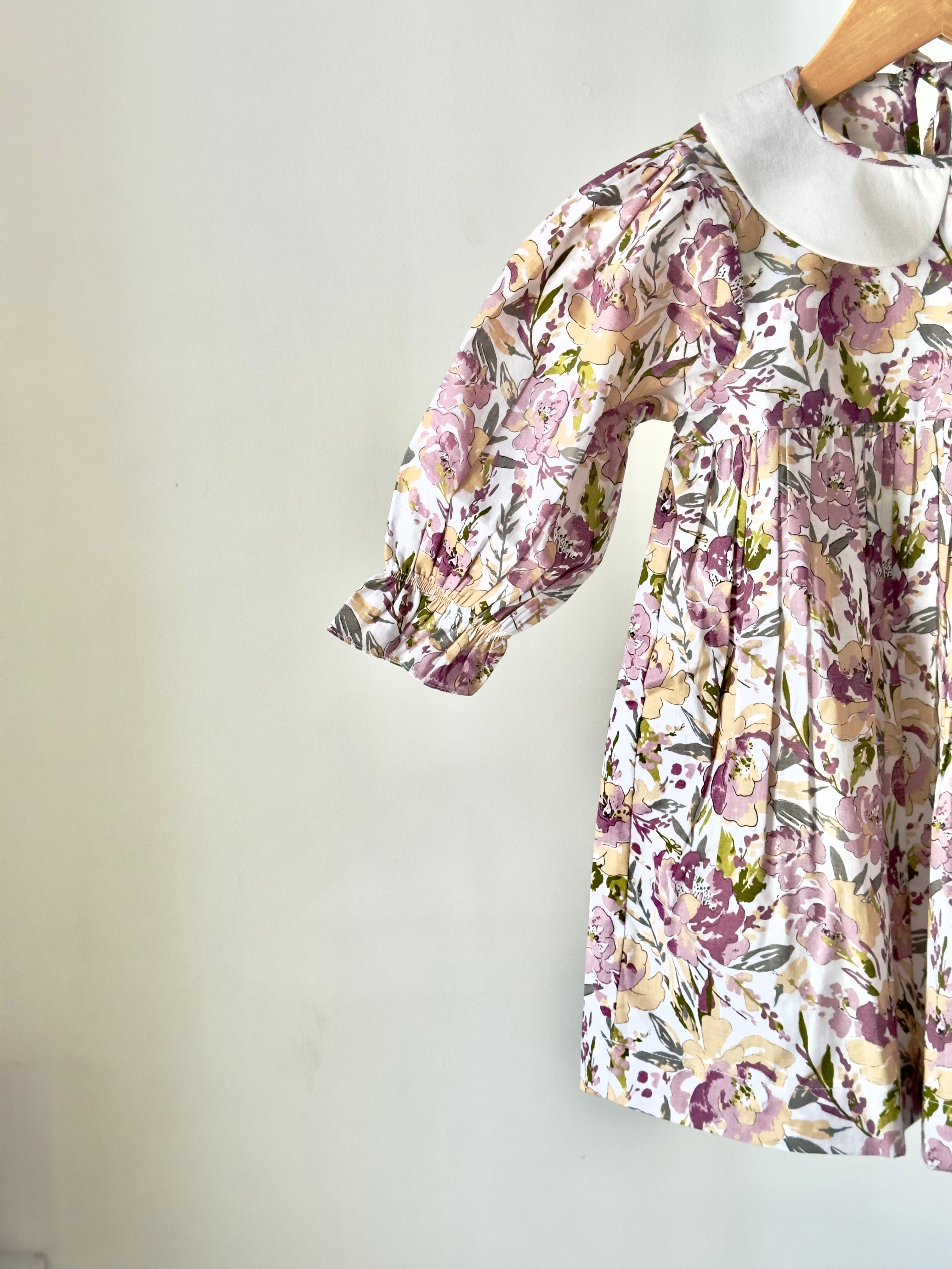 Floral pastel cotton dress with vintage collar displayed on hanger