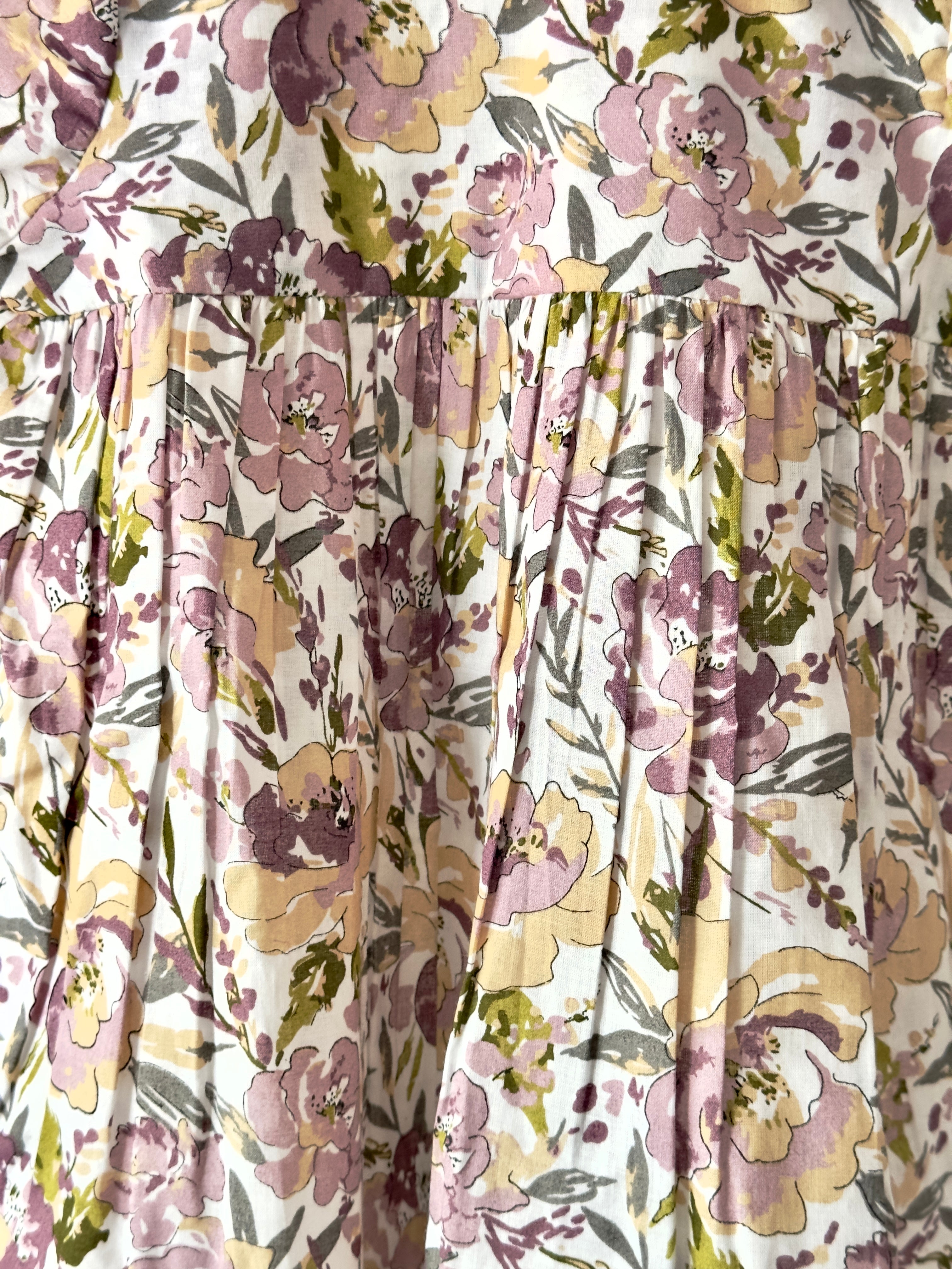 Floral pastel cotton dress with vintage collar displayed on hanger