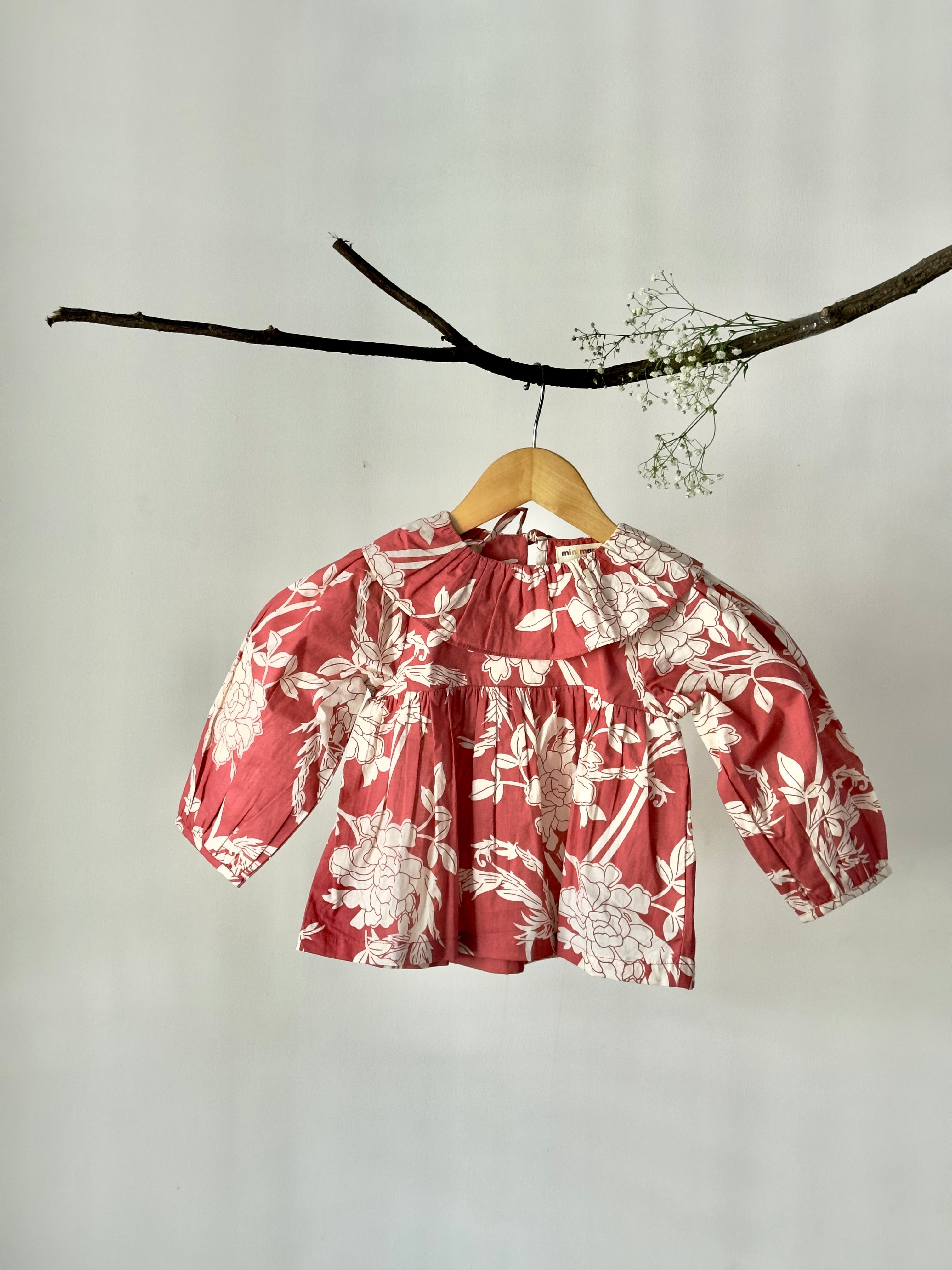 Girls floral top paired with cream cotton bottoms