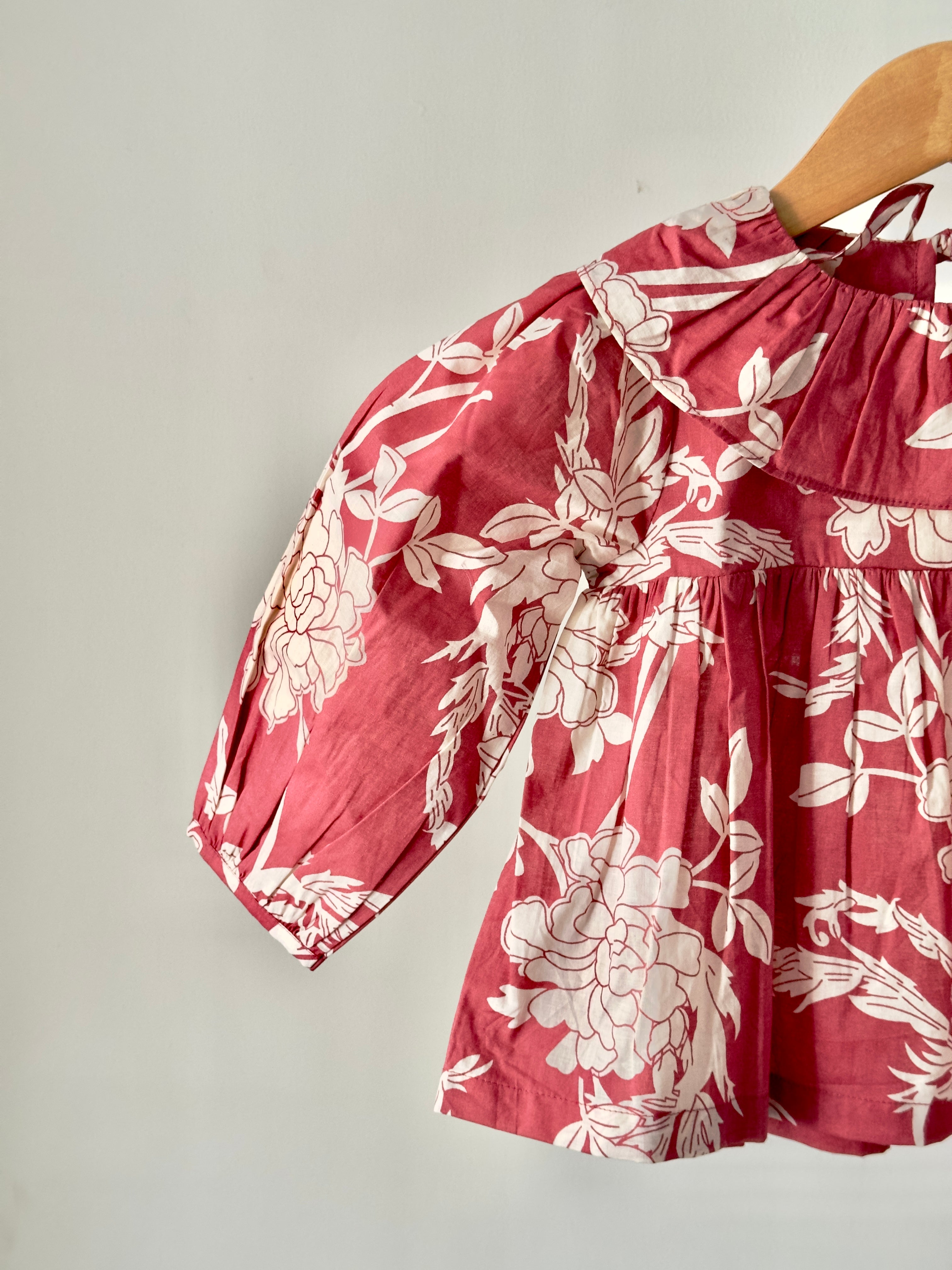 Girls floral top paired with cream cotton bottoms